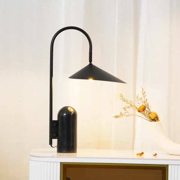 This Arum Table Lamp gives a soft and uniform light with the off-white matte present in the interior of the shade. You can adjust the lampshade to provide the perfect light setting for any occasion