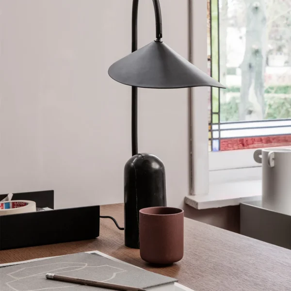 This Arum Table Lamp gives a soft and uniform light with the off-white matte present in the interior of the shade. You can adjust the lampshade to provide the perfect light setting for any occasion