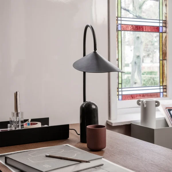 This Arum Table Lamp gives a soft and uniform light with the off-white matte present in the interior of the shade. You can adjust the lampshade to provide the perfect light setting for any occasion