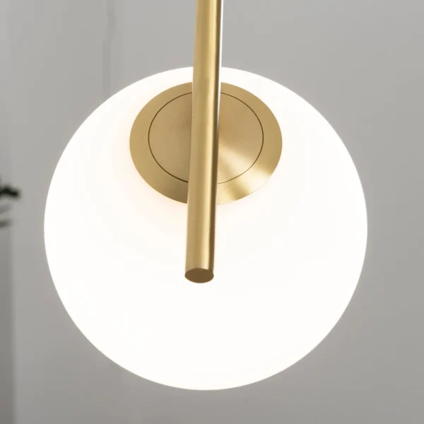 The glass shade of the Lux Round Pendant Light is expertly crafted to perfection, offering a flawless surface that allows the light to filter through beautifully. The rounded shape of the shade adds a sense of softness and fluidity to the design, while the brass accents provide a touch of modern flair.