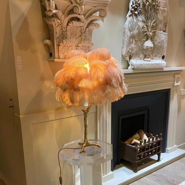 Feather your nest with the Ostrich Feather Table Lamp, romantic and feminine this sultry lamp will make a statement in your bedroom or living room. Its elegant gilded base supports real, Ostrich feathers. 