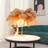 Feather your nest with the Ostrich Feather Table Lamp, romantic and feminine this sultry lamp will make a statement in your bedroom or living room. Its elegant gilded base supports real, Ostrich feathers. 