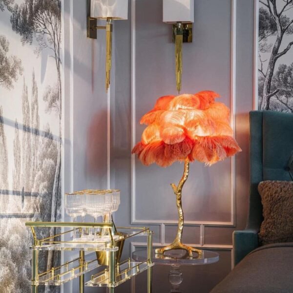 Feather your nest with the Ostrich Feather Table Lamp, romantic and feminine this sultry lamp will make a statement in your bedroom or living room. Its elegant gilded base supports real, Ostrich feathers. 