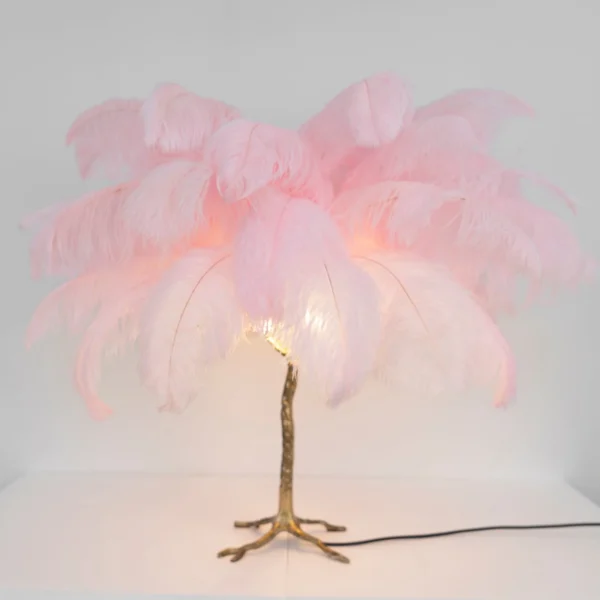 Feather your nest with the Ostrich Feather Table Lamp, romantic and feminine this sultry lamp will make a statement in your bedroom or living room. Its elegant gilded base supports real, Ostrich feathers. 