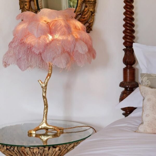 Feather your nest with the Ostrich Feather Table Lamp, romantic and feminine this sultry lamp will make a statement in your bedroom or living room. Its elegant gilded base supports real, Ostrich feathers. 