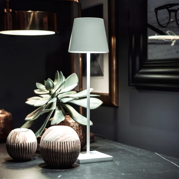 The fixture is made up of metal with LED light source, ensuring a clean display along with a tasteful layer of light. This piece lights the way wherever it is placed, providing a full and inviting glow. Its square base ensures a sturdy display. Purchase Notes: Only supports shipping to Japan, Australia, the EU, and the United States, other countries do not support shipping. If you have any questions about our products, please contact us and we will get back to you within 24 hours. Product Size Size: ∅ 4.3″ x H 15″ / Dia 11cm x H 38cm Details Material: Metal, Acrylic, Aluminum alloy Light source: Integrated LED Voltage: AC 110-240V Battery capacity (mAh): 2000 mAh Charging voltage: 5V---2A or 8V---2A Charging time: ~3 hours to fully charge Continuous discharge time: the maximum power can be used for about 3 hours, and the minimum power can be used continuously for about 10 hours. Color: White, Black, Gold, Pink, Silver Control method: Touch switch (Dimmable) We provide with USB charging cable. Approved: ETL, UL listed and CE, SAA certification.