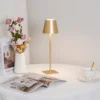The fixture is made up of metal with LED light source, ensuring a clean display along with a tasteful layer of light. This piece lights the way wherever it is placed, providing a full and inviting glow. Its square base ensures a sturdy display. Purchase Notes: Only supports shipping to Japan, Australia, the EU, and the United States, other countries do not support shipping. If you have any questions about our products, please contact us and we will get back to you within 24 hours. Product Size Size: ∅ 4.3″ x H 15″ / Dia 11cm x H 38cm Details Material: Metal, Acrylic, Aluminum alloy Light source: Integrated LED Voltage: AC 110-240V Battery capacity (mAh): 2000 mAh Charging voltage: 5V---2A or 8V---2A Charging time: ~3 hours to fully charge Continuous discharge time: the maximum power can be used for about 3 hours, and the minimum power can be used continuously for about 10 hours. Color: White, Black, Gold, Pink, Silver Control method: Touch switch (Dimmable) We provide with USB charging cable. Approved: ETL, UL listed and CE, SAA certification.