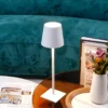 The fixture is made up of metal with LED light source, ensuring a clean display along with a tasteful layer of light. This piece lights the way wherever it is placed, providing a full and inviting glow. Its square base ensures a sturdy display. Purchase Notes: Only supports shipping to Japan, Australia, the EU, and the United States, other countries do not support shipping. If you have any questions about our products, please contact us and we will get back to you within 24 hours. Product Size Size: ∅ 4.3″ x H 15″ / Dia 11cm x H 38cm Details Material: Metal, Acrylic, Aluminum alloy Light source: Integrated LED Voltage: AC 110-240V Battery capacity (mAh): 2000 mAh Charging voltage: 5V---2A or 8V---2A Charging time: ~3 hours to fully charge Continuous discharge time: the maximum power can be used for about 3 hours, and the minimum power can be used continuously for about 10 hours. Color: White, Black, Gold, Pink, Silver Control method: Touch switch (Dimmable) We provide with USB charging cable. Approved: ETL, UL listed and CE, SAA certification.