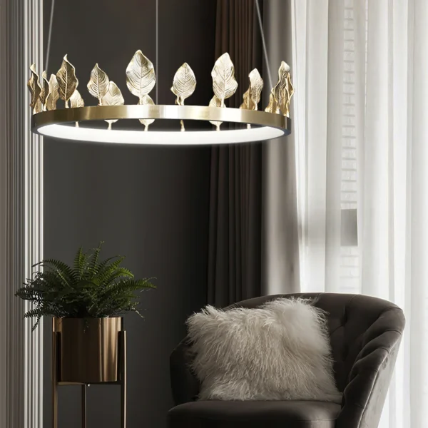 Our Anello Chandelier is shaped like a crown made of laurel leaves. The design is brilliant in a mix of contemporary gold leaf and painted gold finishes. Because the leaves are hand-applied, slight variations in shape may exist on this gold chandelier.