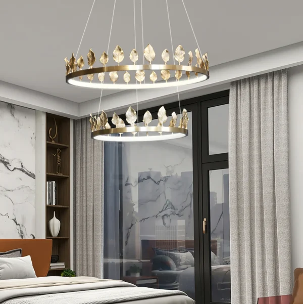 Our Anello Chandelier is shaped like a crown made of laurel leaves. The design is brilliant in a mix of contemporary gold leaf and painted gold finishes. Because the leaves are hand-applied, slight variations in shape may exist on this gold chandelier.