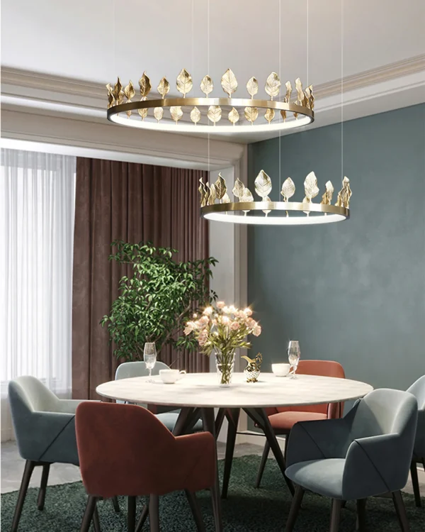 Our Anello Chandelier is shaped like a crown made of laurel leaves. The design is brilliant in a mix of contemporary gold leaf and painted gold finishes. Because the leaves are hand-applied, slight variations in shape may exist on this gold chandelier.