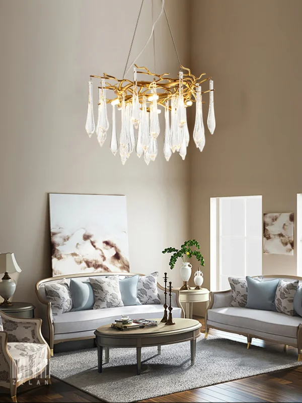 A mesmerizing statement that will inspire awe from above, the fitting features organically formed brass branches dripping with teardrop shapes of handblown glass. Crafted so that it plays with light in an enchanting manner, the chandelier would command attention in a contemporary space.