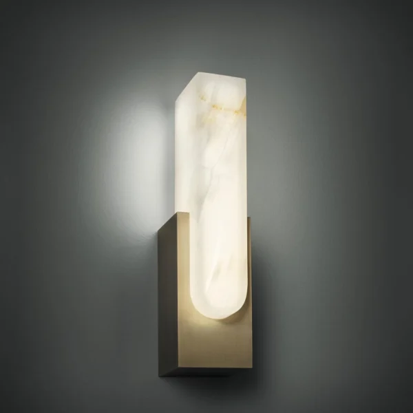 Fusing the purity of brass with the warmth of onyx, the Agatha Sconce revers the natural wonders of both. The inherent translucence of onyx comes alive once turned on, revealing veins and figuring deep in the shade that is unique to each individual one. These age-old materials are assembled around cutting-edge LED technology that ensures the right tones and even cast of light.